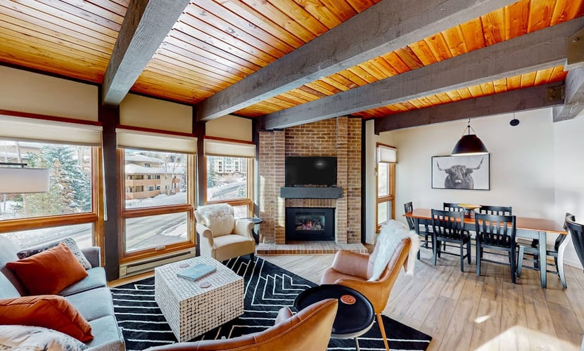 Slopeside condo with pool, hot tubs, ski shuttle, fireplace, & deck