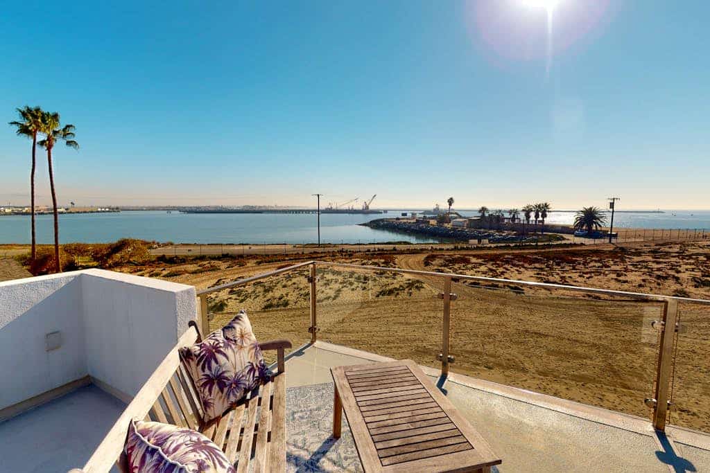 Coastal-themed beachfront home with water views, grill, & beach access