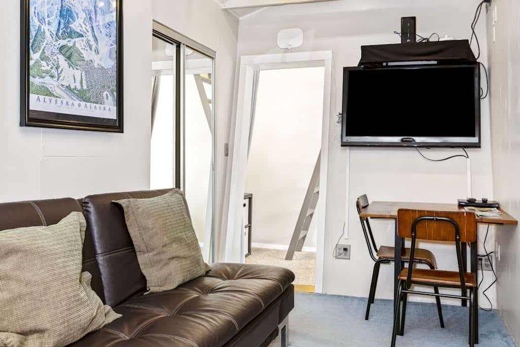 A property built around one flawless logistical idea: walk straight to the lifts, ski all day, and come back to a private hot tub on your own deck. Loveland Cottage sits in the heart of central Girdwood, completely eliminating transit friction from your ski or hiking itinerary. The layout features a fully equipped kitchen built for real meals, an in-unit washer and dryer to keep gear dry, and large windows that pull the forest scenery in. Dogs are welcome to join the campaign, and local restaurants and trail loops are just a brief walk away. Clean, compact, and completely dialed. Standard Specs: Full kitchen, private outdoor hot tub, private washer/dryer, flat-screen TV/DVD, high-speed WiFi, and keypad entry. Driveway parking for two vehicles. Primary renter must be 25 or older. Dog-friendly. Sleeps 6.