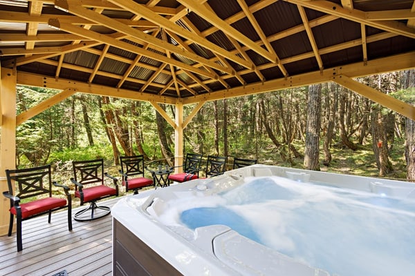 Ullr is the Norse god of snow, and his treehouse is exactly what it sounds like—a highly unique, 1,400 sq. ft. hexagonal cabin that climbs straight up into the spruce canopy across four distinct, 350 sq. ft. levels. Bordering Chugach State Park land, the back path connects you to Beaver Pond Trail for foot treks into town. The layout rises into the trees to offer intimate, custom spaces: a basement media room with a PS4, a second-floor leather lounge and compact kitchen, and a lofted primary bedroom under sloped timbers. Outside, a massive hot tub waits beneath the old-growth tree canopy. *Just be ready to summon your inner mountain goat for the four flights of stairs.* Standard Specs: Full compact kitchen, outdoor hot tub, gas fireplace, private washer/dryer, PS4 console, flat-screen TVs, high-speed WiFi, and keypad entry. Driveway parking for up to four vehicles. On the Glacier Valley Transit route. Sleeps 6.