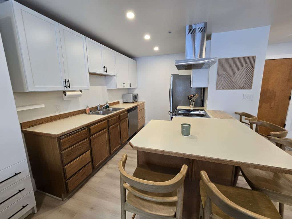 A clever second-floor studio condo engineered for the kind of alpine trip where mornings start directly at the lift and evenings end at the village brewery. Sited ski-in/ski-out at the base of Alyeska Resort, this property puts cafes, pubs, and premier ski trails right at your doorstep. The layout features a well-equipped full kitchen, a four-person breakfast bar for efficient pre-ski fuel, and a functional Murphy bed setup with a dedicated curtain partition to separate the sleeping space from the living lounge. Take your morning coffee out onto the furnished private balcony pointed straight at the Chugach peaks. *No elevator.* Standard Specs: Full kitchen with breakfast bar, private balcony, curtain privacy partition, flat-screen TV, high-speed WiFi, and keypad entry. Dedicated parking for one vehicle. Fireplace non-operational per local regulations. Building requires stair access. Sleeps 4.