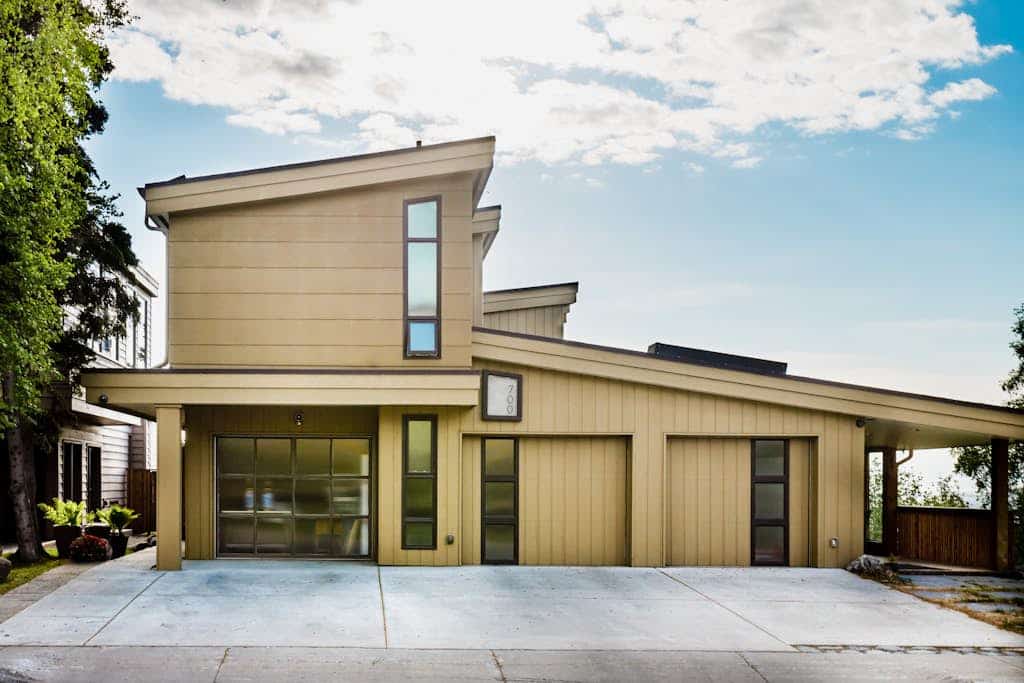 The complete, park-like M Street estate—combining three independent, high-end mid-century modern vacation rentals into a single downtown Anchorage triplex compound. Offering three independent private hot tubs, a lushly landscaped shared garden paradise, pro gas grills, and alfresco dining decks, this property is an unmatched asset built specifically for weddings, corporate retreats, reunions, and large-scale group getaways. The expansive Cook Inlet and mountain views continue inside, where the top-floor primary residence features an award-winning gourmet kitchen featured in Alaska's Best Kitchens Magazine—packed with a solid redwood island, a Miele cooktop, a steam oven, convection oven, and dual dishwashers. Walking distance to the Coastal Trail, Performing Arts Center, and downtown dining. Standard Specs: Three fully equipped kitchen/kitchenette spaces, grand-prize chef's kitchen, three private hot tubs, shared gardens with gas grills, fireplaces, flat-screen TVs, high-speed WiFi, and keypad entry. Off-street driveway parking for three vehicles. Enforces strict zero-tolerance guest capacity policies. Sleeps 16.