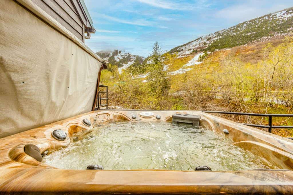 Three full floors of beautifully updated alpine space, direct views of Alyeska Mountain, and a private outdoor hot tub pointed straight at the peaks. Alyeska Slopeside B-4 is an uncompromised ski-in/ski-out townhome condo designed to make a long ski week or summer trail campaign completely effortless. The updated, open-concept floor plan spreads a group comfortably across multiple levels, featuring a pro kitchen with stainless steel appliances, a dedicated wine fridge, an extensive sectional sofa with a smart streaming TV, and a private gas grill on the deck for summer cookouts. Walk straight onto the ski trails or look over the board games on the shelf on snowy valley nights. Standard Specs: Fully equipped kitchen, wine fridge, private outdoor hot tub, deck with gas grill, board games, in-unit washer/dryer, flat-screen Smart TV with streaming, high-speed WiFi, and keypad entry. Parking space for three vehicles. True ski-in/ski-out access. Sleeps 8.