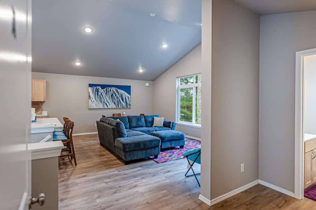 Both independent sides of our premium Girdwood duplex combined into a single, high-capacity mountain home sleeping up to ten guests under one roof. It is the perfect operational call when your family group is larger than a single unit can handle, but you still want everyone sharing the same basecamp. The open-concept layout features modern radiant floor heating throughout, two fully equipped kitchens with stainless steel appliances, two distinct living rooms with oversized sofas and Smart TVs, and a child's playroom packed with toys and books. Step outside to access dual viewing decks and a shared grilling area framed by breathtaking views of the surrounding Girdwood wilderness. Walk to the Virgin Creek Trailhead. Standard Specs: High-capacity duplex layout with two full kitchens, radiant floor heat, shared gas grilling decks, mountain views, private washer/dryers, Pack-N-Plays, child's toys, flat-screen Smart TVs, high-speed WiFi, and keypad entry. Driveway parking for up to four vehicles. No A/C. Sleeps 10.