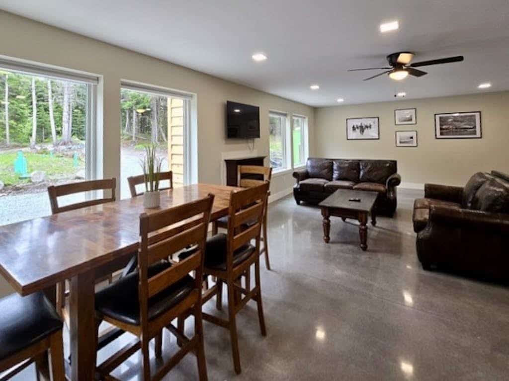 The independent lower-level residence of the Monarch Mine estate—a beautifully updated three-bedroom duplex suite that accommodates up to six guests with complete comfort and privacy. The layout features a private ground-floor entrance, a fully equipped kitchen, and a cozy living area built for winding down after Alaskan backcountry trail runs. Walk straight out to the large lot, fire up the grill, or take a 5-minute walk to the Great Alaska Railroad Girdwood Depot for effortless regional transit. Offers the exact same premium Bird-to-Gird trail path and Alyeska Resort access as the upper unit at a smaller scale. *Please note: As a lower-level duplex suite, you may occasionally hear footsteps from the upper unit.* Standard Specs: Fully equipped kitchen, private ground-floor entrance, private mountain-view patio, flat-screen TV with streaming access, high-speed WiFi, and keypad entry. Lower duplex layout. Driveway parking for up to four vehicles. Sleeps 6.