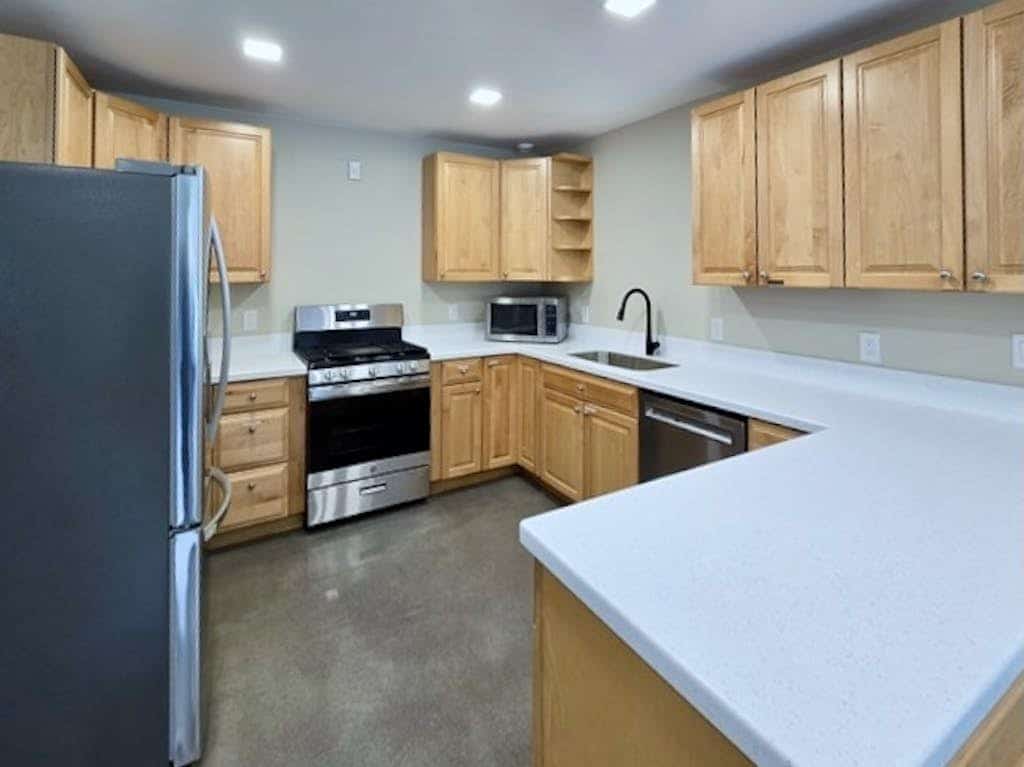 The independent lower-level residence of the Monarch Mine estate—a beautifully updated three-bedroom duplex suite that accommodates up to six guests with complete comfort and privacy. The layout features a private ground-floor entrance, a fully equipped kitchen, and a cozy living area built for winding down after Alaskan backcountry trail runs. Walk straight out to the large lot, fire up the grill, or take a 5-minute walk to the Great Alaska Railroad Girdwood Depot for effortless regional transit. Offers the exact same premium Bird-to-Gird trail path and Alyeska Resort access as the upper unit at a smaller scale. *Please note: As a lower-level duplex suite, you may occasionally hear footsteps from the upper unit.* Standard Specs: Fully equipped kitchen, private ground-floor entrance, private mountain-view patio, flat-screen TV with streaming access, high-speed WiFi, and keypad entry. Lower duplex layout. Driveway parking for up to four vehicles. Sleeps 6.