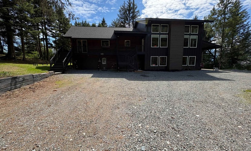 The independent lower-level residence of the Monarch Mine estate—a beautifully updated three-bedroom duplex suite that accommodates up to six guests with complete comfort and privacy. The layout features a private ground-floor entrance, a fully equipped kitchen, and a cozy living area built for winding down after Alaskan backcountry trail runs. Walk straight out to the large lot, fire up the grill, or take a 5-minute walk to the Great Alaska Railroad Girdwood Depot for effortless regional transit. Offers the exact same premium Bird-to-Gird trail path and Alyeska Resort access as the upper unit at a smaller scale. *Please note: As a lower-level duplex suite, you may occasionally hear footsteps from the upper unit.* Standard Specs: Fully equipped kitchen, private ground-floor entrance, private mountain-view patio, flat-screen TV with streaming access, high-speed WiFi, and keypad entry. Lower duplex layout. Driveway parking for up to four vehicles. Sleeps 6.