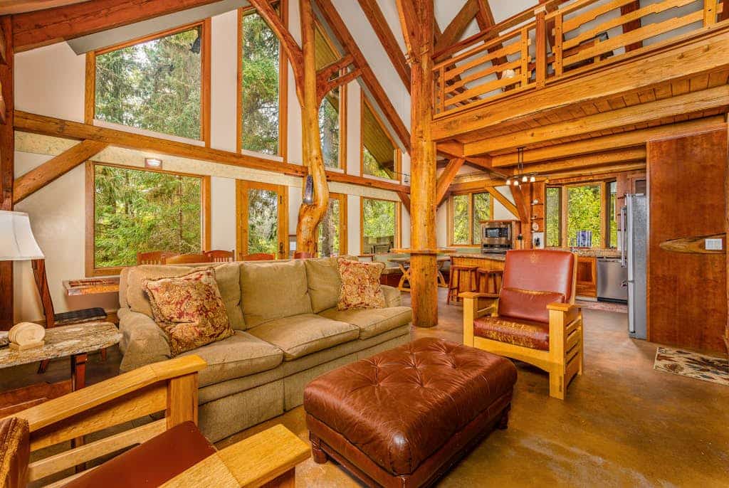 There is a moment when the highway falls away, the spruce closes in, and the only sound is the water out back. That is Iris Pond. Handcrafted with custom wood-carved interiors, this private Girdwood cabin pairs rugged Alaska character with polished hospitality, sitting just a few minutes from the chairlifts at Alyeska. The open layout features large windows framing the forest, a fully equipped chef's kitchen, and a seamless transition to the back deck where a private hot tub waits beneath the trees. It is a quiet, clean basecamp built for slow mornings with local coffee and long evenings after hiking Chugach National Forest trailheads or chasing deep powder. Standard Specs: Fully equipped kitchen, private washer/dryer, flat-screen TV, high-speed WiFi, and keypad entry. Safe parking for up to four vehicles. Sleeps 7.