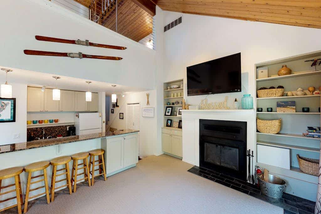 Girdwood lives at a slower rhythm, and this remodeled, split-level condo fits right into it. Tucked into a quiet stand of forest in central Girdwood, the home features clean views out every single window and the kind of quiet that makes you forget how close you are to the village core. The two-story layout easily handles a full crew without feeling crowded, offering a bright living zone centered around a stone gas fireplace, an updated kitchen, and a master bathroom with a deep jetted soaking tub to revive trail-weary legs. Walk out your door to find the local bike path, The Bake Shop, and the local mercantile just minutes away. Standard Specs: Full kitchen with dishwasher, private full-size washer/dryer, flat-screen cable TV, high-speed WiFi, and keypad entry. Dedicated parking for two vehicles. Sleeps 7.