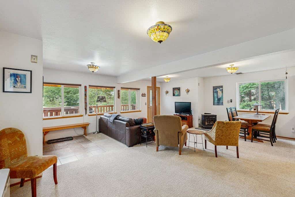 Tucked into the historic mine roads above the valley, Jewel Chalet trades the bustle of the village center for a quieter, more peaceful rhythm. Positioned in an exceptional walking neighborhood near the Turnagain Arm and the Seward Highway, this comfortable home serves as an effortless staging ground for sea kayaking, dog sledding, or winter ski trips. The inviting interior features a clean open layout, a powerful gas fireplace, and two oversized full bathrooms that make cleaning up gear seamless. Step out onto the large covered balcony to grill on the propane barbecue while taking in the fresh mountain air, or use the high-speed WiFi to check local trail conditions. Standard Specs: Fully equipped kitchen, two full bathrooms, gas fireplace, covered deck with propane grill, cable TV, high-speed WiFi, and keypad entry. Driveway parking for two vehicles. Dog-friendly. No A/C. Sleeps 4.