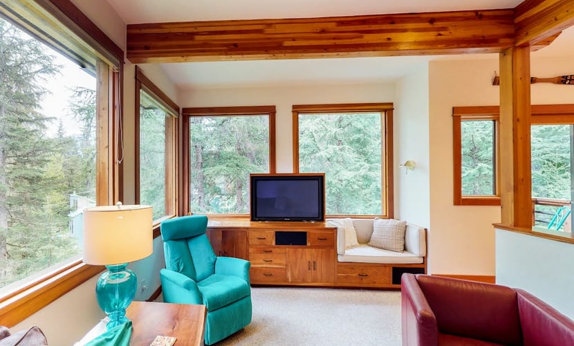 The full St. Moritz property combines a sprawling three-story main residence and an adjoining studio apartment into a single hillside compound—offering the perfect multi-generation layout for groups who want to stay under one roof without piling on top of each other. Located a quiet mile from Alyeska Resort, the estate features two independent full kitchens, two living rooms, an authentic wood stove, and a private jetted soaking tub. Large windows and a third-floor observation balcony capture clear views of old-growth timber and valley peaks. *Winter notice: The hillside location means 4x4 vehicles are strictly required during snowy months.* Standard Specs: Two full kitchens, private laundry, wood stoves, jetted tub, flat-screen TVs, high-speed WiFi, and keypad entry. Driveway parking for two vehicles (street parking available). Includes comprehensive damage waiver. No A/C. Sleeps 10.