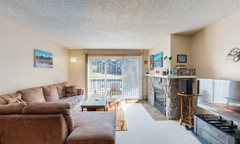 A rock-solid, practical two-bedroom Girdwood condo that gets the mountain basics exactly right. Positioned a short walk from the Alyeska Resort chairlifts, the home serves as a reliable, comfortable basecamp for ski weeks or summer hiking campaigns into the Chugach Range. The open layout features clean mountain views right from the living room windows, a powerful gas fireplace for cold winter nights, a full kitchen with a breakfast bar that handles a full crew, and quick transit reach to the rest of the Kenai Peninsula when the weekend gets longer. Standard Specs: Fully equipped kitchen with breakfast bar, gas fireplace, flat-screen TV/DVD, high-speed WiFi, and keypad entry. Dedicated parking for two vehicles. Sleeps 6.