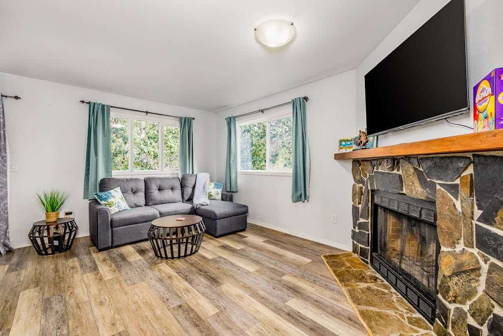 The kind of Anchorage neighborhood home that instantly feels like staying with close friends. Tucked into a quiet residential street with a scenic community walking trail right at the end of the block, the Carriage House boasts quality furnishings, a massive formal dining table, and a completely fenced side yard built for family cookouts on the gas grill. The clean interior features a fully stocked kitchen with real culinary tools, large reclining living room spaces for winding down together, and bedrooms outfitted with premium comfort in mind. A short drive connects you to downtown Anchorage, Kincaid Park, and the Coastal Trail. Dogs are completely welcome to join the team. Standard Specs: Fully equipped kitchen, private fenced yard, gas grill, private washer/dryer, flat-screen TV, high-speed WiFi, and keypad entry. Driveway parking for one vehicle. Fireplace non-operational. Dog-friendly. Sleeps 6.