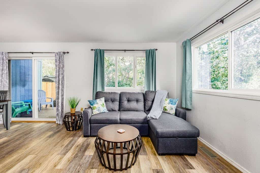The kind of Anchorage neighborhood home that instantly feels like staying with close friends. Tucked into a quiet residential street with a scenic community walking trail right at the end of the block, the Carriage House boasts quality furnishings, a massive formal dining table, and a completely fenced side yard built for family cookouts on the gas grill. The clean interior features a fully stocked kitchen with real culinary tools, large reclining living room spaces for winding down together, and bedrooms outfitted with premium comfort in mind. A short drive connects you to downtown Anchorage, Kincaid Park, and the Coastal Trail. Dogs are completely welcome to join the team. Standard Specs: Fully equipped kitchen, private fenced yard, gas grill, private washer/dryer, flat-screen TV, high-speed WiFi, and keypad entry. Driveway parking for one vehicle. Fireplace non-operational. Dog-friendly. Sleeps 6.