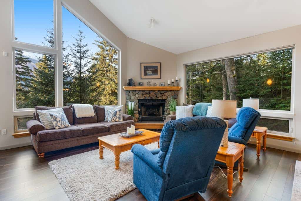 Penguin Ridge sits directly across the valley—and from the private deck of this peaceful family cabin, it completely owns the view. Enclosed by mature spruce and hemlock, this property feels completely isolated from the rest of the world while sitting less than a mile from the Alyeska Resort Day Lodge and Girdwood’s village center. The cabin architecture features high windows that flood the rustic interior with natural light, a ceramic log fireplace that anchors the open family living room, and a massive upstairs sleeping loft that easily handles extra guests and kids. Spend your days exploring the Chugach wilderness, and your nights soaking in the private hot tub under the trees. Standard Specs: Fully equipped kitchen, private outdoor hot tub, ceramic log fireplace, sleeping loft, private washer/dryer, flat-screen TV, high-speed WiFi, and hospitality check-in instructions. Driveway parking for up to four vehicles. Strict quiet hour compliance (10 PM–8 AM). Non-smoking. Sleeps 10.