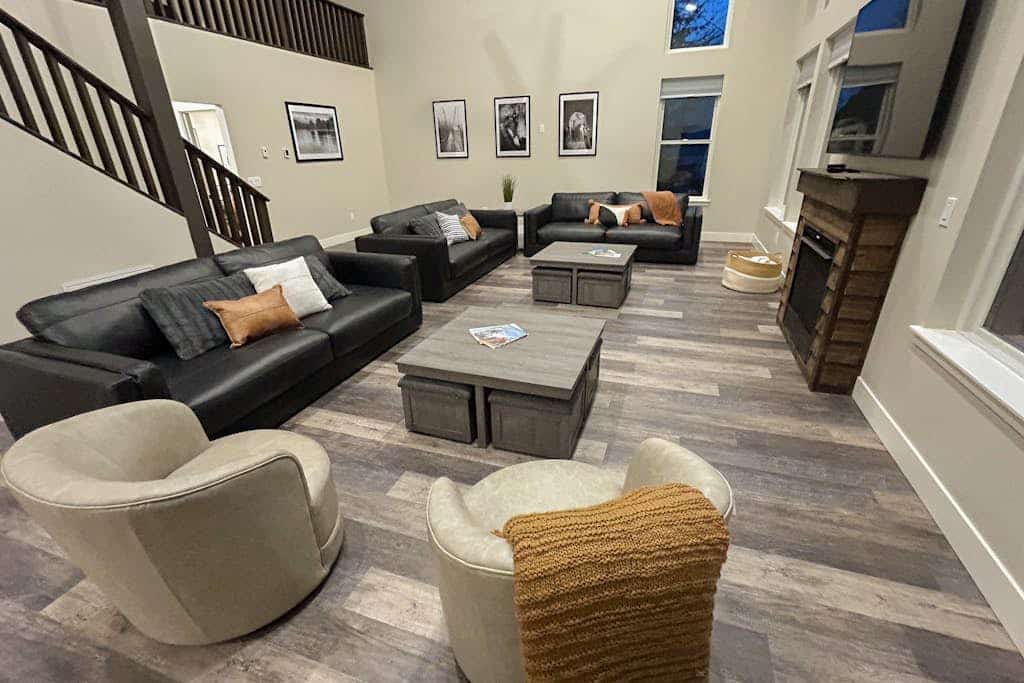 When the corporate retreat, family reunion, or wedding party requires a footprint larger than a standard mountain house can handle—The Monarch handles it with ease. This newly remodeled 9-bedroom plus loft Girdwood estate comfortably sleeps up to twenty-one guests across two independent, masterfully crafted duplex levels (Unit A and Unit B). The private lot features a massive viewing deck for morning coffee, a pro gas grill, and a custom stone fire pit for long evenings under the stars. The interior provides multiple open living zones, dual fully equipped kitchens, a stone fireplace, and bedrooms with data-verified mountain views. The iconic Bird-to-Gird biking path sits steps from the door, the Girdwood Train Depot is a 5-minute walk, and Alyeska Resort is minutes ahead. Standard Specs: Sprawling duplex compound with dual full kitchens, stone fireplace, stone fire pit, gas grill, flat-screen streaming TVs, high-speed WiFi, and keypad entry. Massive private lot with parking space for up to ten vehicles. Walk to Girdwood Station. Sleeps 21.