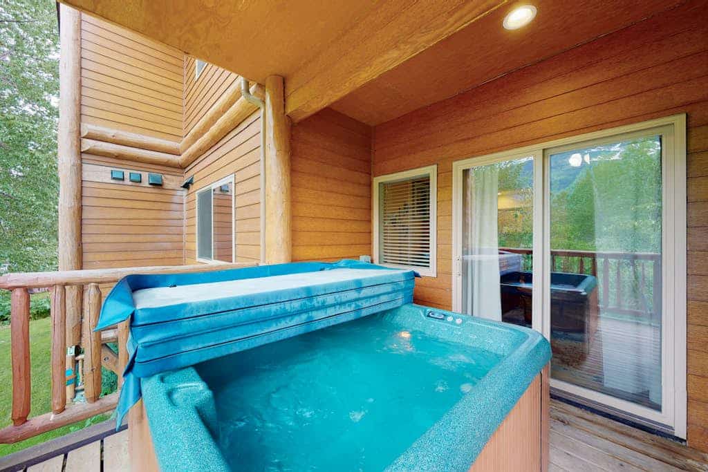 Positioned securely on the second floor of a premier building just a mile from Alyeska Resort, Creekside Retreat delivers clean mountain views out of every single window. Serving as a flawless, highly reliable two-bedroom condo, the home sits within short walking distance of Girdwood’s favorite coffee shops, local restaurants, and the mercantile. Treat your muscles to a deep soak in your private hot tub on the deck while taking in the peaks, or gather inside around the living room's cozy gas fireplace and flat-screen TV. The bright, airy layout is fully functional, offering a well-appointed kitchen with stainless steel appliances and an in-unit washer and dryer. Standard Specs: Fully equipped kitchen with stainless steel appliances, private outdoor hot tub, gas fireplace, private deck, private washer/dryer, flat-screen TV, high-speed WiFi, and keypad entry. Positioned in a secure building with parking for two vehicles. Includes pull-out bedding options. Sleeps 4.