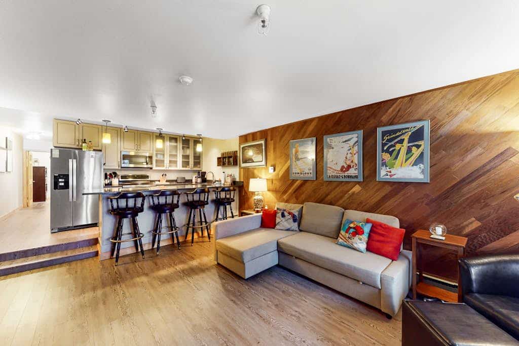 A dog-friendly ski-in/ski-out condo positioned directly at the base of Mt. Alyeska—the rare mountain combination that actually works. Decorated with authentic vintage ski posters, warm wood finishes, and alpine mementos, this cozy condo lets a couple or small family spread out without overcomplicating their vacation logistics. Slide straight off the ski trail and onto your private patio, or cook a real meal in the fully equipped kitchen featuring stainless steel appliances and generous meal-prep space. Glaciers, hiking trails, and local village dining spots are all within a short drive, while the shared on-site laundry keeps all your outdoor gear refreshed. Standard Specs: Fully equipped kitchen with stainless steel appliances, private patio, warm wood interiors, vintage decor, flat-screen Smart TV, keypad entry, and shared building laundry. Dedicated parking for one vehicle. Dog-friendly. No A/C. Sleeps 4.