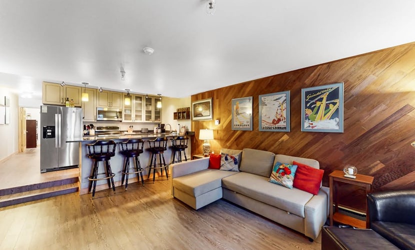 A dog-friendly ski-in/ski-out condo positioned directly at the base of Mt. Alyeska—the rare mountain combination that actually works. Decorated with authentic vintage ski posters, warm wood finishes, and alpine mementos, this cozy condo lets a couple or small family spread out without overcomplicating their vacation logistics. Slide straight off the ski trail and onto your private patio, or cook a real meal in the fully equipped kitchen featuring stainless steel appliances and generous meal-prep space. Glaciers, hiking trails, and local village dining spots are all within a short drive, while the shared on-site laundry keeps all your outdoor gear refreshed. Standard Specs: Fully equipped kitchen with stainless steel appliances, private patio, warm wood interiors, vintage decor, flat-screen Smart TV, keypad entry, and shared building laundry. Dedicated parking for one vehicle. Dog-friendly. No A/C. Sleeps 4.
