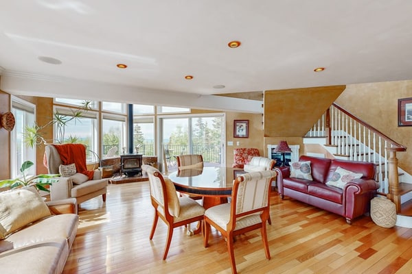 Positioned south of downtown Anchorage where the neighborhood quiets down and the local moose still regularly wander through the yard. This cozy upper-floor apartment serves as an exceptional retreat, located close to the Alaska Zoo, O'Malley's golf course, and local eateries. The architecture is engineered for cold-weather comfort, featuring premium radiant floor heating, a private indoor jetted tub, and an authentic wood stove inside the living lounge. Step out onto the massive shared front deck to soak in the bubbly outdoor hot tub while taking in views of the surrounding tree canopy and looking out for visiting wildlife. Standard Specs: Fully equipped kitchen, shared outdoor hot tub, large observation deck, wood stove, indoor jetted tub, radiant floor heating, flat-screen TV, high-speed WiFi, and keypad entry. Upper-floor layout. Driveway parking for two vehicles. Sleeps 5.