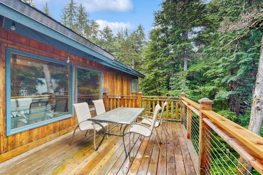 The kind of Girdwood home that completely earns the word welcoming—offering a warm, timber-accented open layout, comfortable bedrooms, and a fully equipped kitchen built for hosting dinners with friends at the end of a long trail day. Step out onto the private forested deck to unwind under the stars in your luxury outdoor hot tub, or stoke the fireplace inside. Positioned just a few minutes from the chairlifts at Alyeska Resort, the home sits within easy walking distance of the Alyeska Nordic Spa, the Double Musky Inn, and Girdwood Brewing Company. Dogs are welcome to join. Standard Specs: Fully equipped kitchen, private outdoor hot tub, fireplace, flat-screen TV, high-speed WiFi, and keypad entry. Driveway parking for two vehicles. Dog-friendly. Sleeps 7.