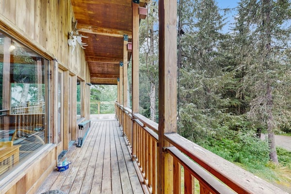 The kind of Girdwood home that completely earns the word welcoming—offering a warm, timber-accented open layout, comfortable bedrooms, and a fully equipped kitchen built for hosting dinners with friends at the end of a long trail day. Step out onto the private forested deck to unwind under the stars in your luxury outdoor hot tub, or stoke the fireplace inside. Positioned just a few minutes from the chairlifts at Alyeska Resort, the home sits within easy walking distance of the Alyeska Nordic Spa, the Double Musky Inn, and Girdwood Brewing Company. Dogs are welcome to join. Standard Specs: Fully equipped kitchen, private outdoor hot tub, fireplace, flat-screen TV, high-speed WiFi, and keypad entry. Driveway parking for two vehicles. Dog-friendly. Sleeps 7.
