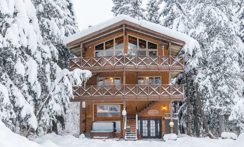 The trick to a successful group trip is having a house engineered to handle the headcount—and Chateau Cervin handles it seamlessly. Tucked into a quiet cul-de-sac just moments from the Alyeska resort chairlifts, this high-capacity chalet looks out over uncompromised views of Max's Mountain. The expansive floor plan splits the crowd intelligently across multiple levels, featuring two full kitchens on separate floors, two independent living areas with fireplaces, and a massive lower-level gear-staging and game room equipped with a pool table and foosball. After a day on the snow, gather on the covered porch for a long soak in the oversized private hot tub. Standard Specs: High-capacity layout with two full kitchens, two fireplaces, private washer/dryer, flat-screen TVs, high-speed WiFi, and keypad entry. Massive private driveway with parking space for six vehicles. Sleeps 15.