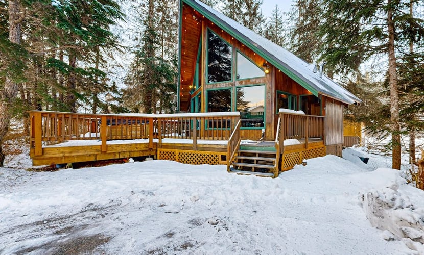 Some properties are styled to look like old Girdwood. This one actually is Girdwood. Preserving the architectural culture of the valley's early ski days, this classic A-frame chalet features original open-beam wood interiors, towering windows, and an open floor plan that lets the mountain light all the way in. Modern updates are placed thoughtfully where they matter most—including a reliable gas heating stove and a traditional, wood-powered cedar barrel sauna right outside the front door to handle muscle recovery. Located in an established neighborhood close to the hill, it sits directly on the paved path running toward Virgin Creek Falls trailhead. Standard Specs: Full kitchen with dishwasher, private washer/dryer, flat-screen TV, high-speed WiFi, and keypad entry. Dedicated parking for two vehicles. Guests can easily purchase firewood for the sauna locally. Sleeps 5.
