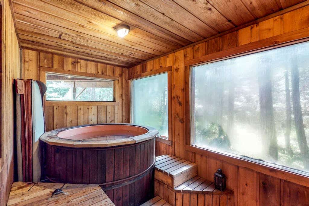 A dense spruce forest closes in on three sides of this striking open-beam chalet, delivering deep serenity just a short drive from Alyeska Resort and minutes from Girdwood’s local trailheads and breweries. The architecture features soaring big-beam construction and massive windows that bring the old-growth canopy right into your living room. The layout is defined by two standout features: a sun-drenched glass solarium that turns morning coffee into a slow ritual, and a massive private hot tub on the back deck for starlit evening wind-downs. The interior is warm and human, featuring a powerful wood stove, recent premium flooring updates, and a dog-friendly policy. Standard Specs: Fully equipped kitchen, private full-size washer/dryer, wood stove, flat-screen TV, high-speed WiFi, and keypad entry. Driveway parking for up to three vehicles. Dog-friendly. Sleeps 9.