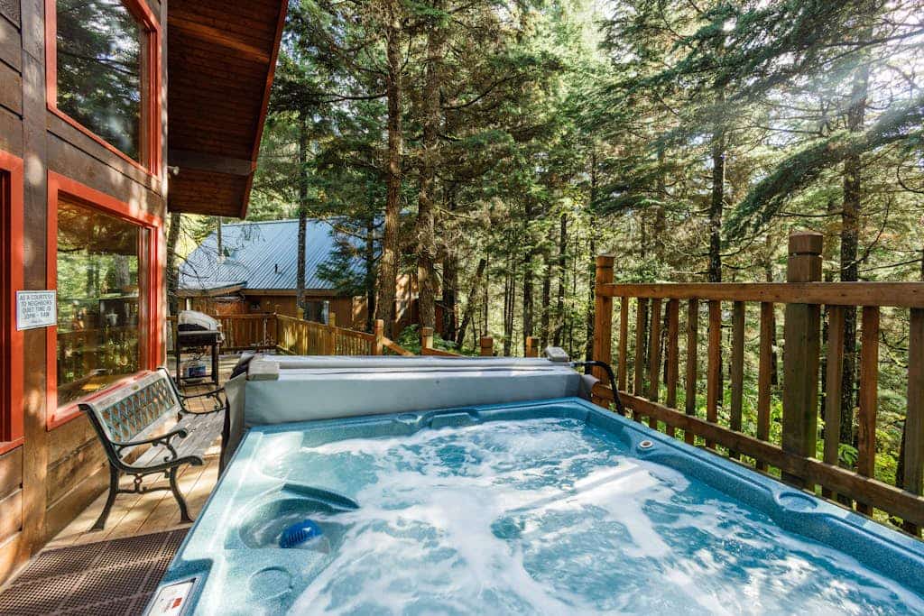 Big timber beams, soaring vaulted ceilings, and a private hot tub waiting under the spruce canopy—Vail Chalet delivers an authentic lodge-style retreat. Located a short walk from Girdwood’s trailheads and a brief drive to Alyeska Resort, the home looks out over the mountain lights in the winter and wild berry patches in the summer. The interior has been completely updated to meet modern standards, featuring a premium kitchen with a new LG refrigerator, fresh furnishings, and a primary bedroom suite with its own private gas fireplace. A second fireplace anchors the main living room, offering a warm sanctuary for groups and their dogs. Standard Specs: Fully equipped kitchen, private outdoor hot tub, two fireplaces, propane grill, private washer/dryer, cable TV/DVD, high-speed WiFi, and keypad entry. Parking for two vehicles. Dog-friendly. Sleeps 8.