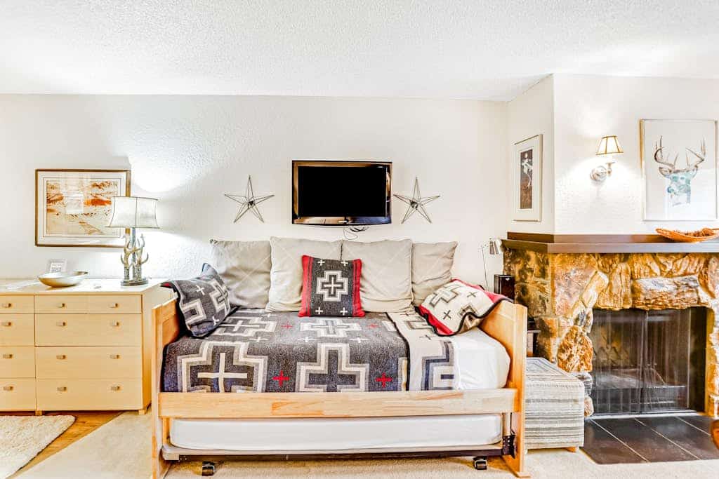 A crisp, practical studio condo positioned a short walk from the Alyeska chairlifts in central Girdwood, making it the ideal basecamp for travelers who would rather spend their time exploring the mountain than sitting inside a room. The floor plan focuses entirely on utility, offering a private balcony for morning mountain views, a well-equipped kitchen with a full dishwasher, and immediate access to the building's deep-heat shared sauna to flush out the miles after a long day on the snow. Walking distance to the village's best restaurants, art galleries, and grocery loops. Standard Specs: Well-equipped kitchen with dishwasher, private balcony, flat-screen cable TV, high-speed WiFi, keypad entry, and shared building sauna. Parking for one vehicle. Fireplace is decorative/non-operational. No A/C. Sleeps 4.