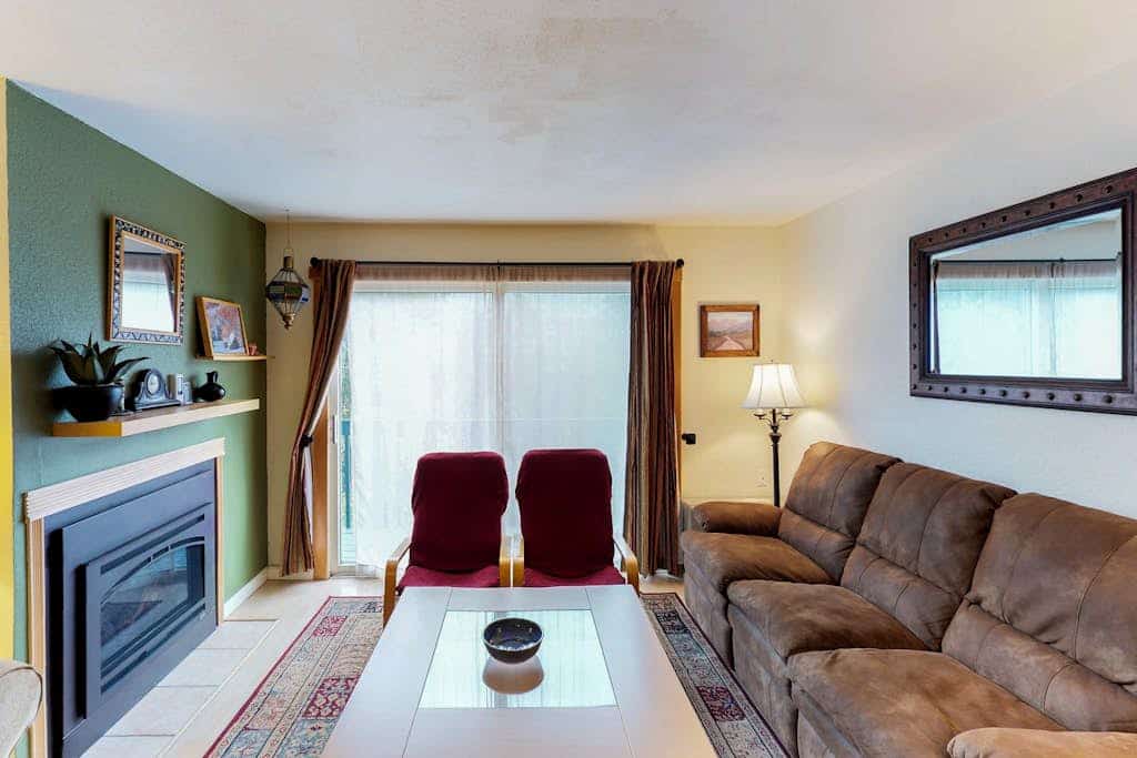 Renovated completely where it counts while keeping its original mountain character intact, this two-story townhouse condo sits a short walk from the Alyeska chairlifts in central Girdwood. The layout features an open kitchen-living area anchored by a powerful gas fireplace, a private balcony for taking in the cool valley air, and a custom spiral staircase climbing to the upper loft bedrooms. Walk to skiing, catch a Nordic trail at Moose Meadow Park just a couple blocks north, or stroll over to the local mercantile and galleries. Standard Specs: Fully equipped kitchen, gas fireplace, private balcony, flat-screen TVs, high-speed WiFi, and keypad entry. Dedicated parking for two vehicles. Two-story layout. Sleeps 6.