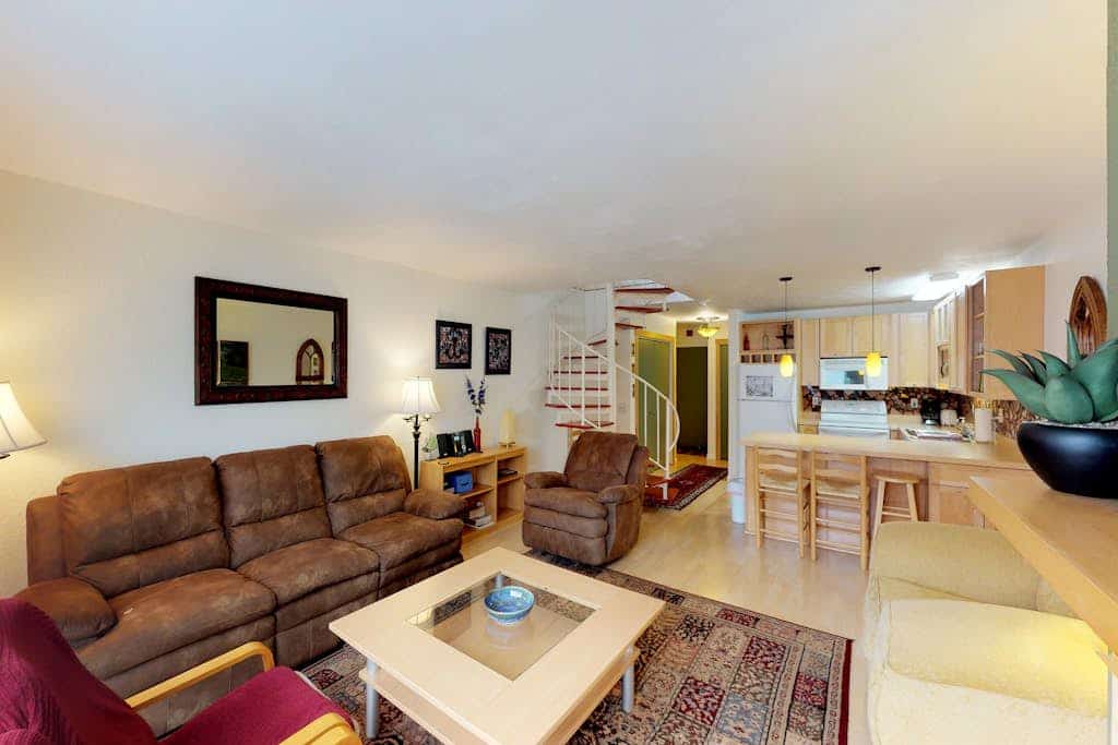 Renovated completely where it counts while keeping its original mountain character intact, this two-story townhouse condo sits a short walk from the Alyeska chairlifts in central Girdwood. The layout features an open kitchen-living area anchored by a powerful gas fireplace, a private balcony for taking in the cool valley air, and a custom spiral staircase climbing to the upper loft bedrooms. Walk to skiing, catch a Nordic trail at Moose Meadow Park just a couple blocks north, or stroll over to the local mercantile and galleries. Standard Specs: Fully equipped kitchen, gas fireplace, private balcony, flat-screen TVs, high-speed WiFi, and keypad entry. Dedicated parking for two vehicles. Two-story layout. Sleeps 6.