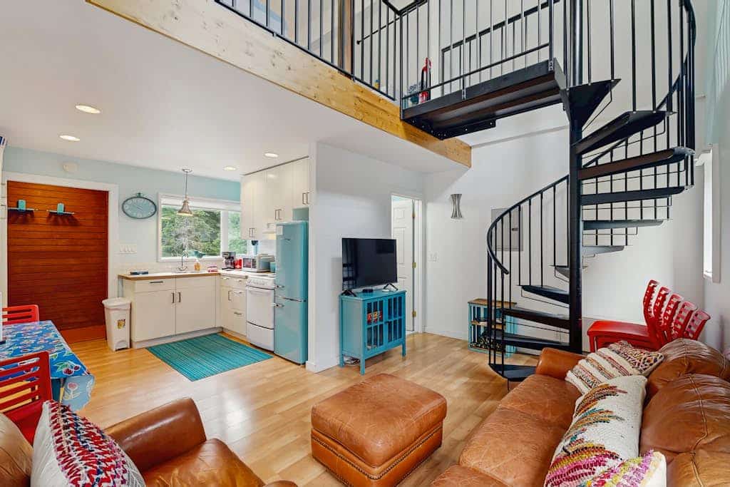 A mountain cottage with distinct personality. Positioned within easy walking distance of the Alyeska Resort Daylodge, Kabina on Vail showcases hand-built character, vibrant custom interiors, and a unique spiral staircase climbing to a private lofted bedroom. The layout is engineered to support an active trail rhythm: hang your gear in the mudroom area, prep a high-energy meal in the full kitchen featuring custom wooden countertops, and watch the stars from the large windows. Completely different from standard condo lodging, in the absolute best way possible. Standard Specs: Fully equipped kitchen with wood countertops, custom loft layout, flat-screen TV, high-speed WiFi, and keypad entry. Dedicated parking for one vehicle. Located 30 miles from Anchorage. Sleeps 4.