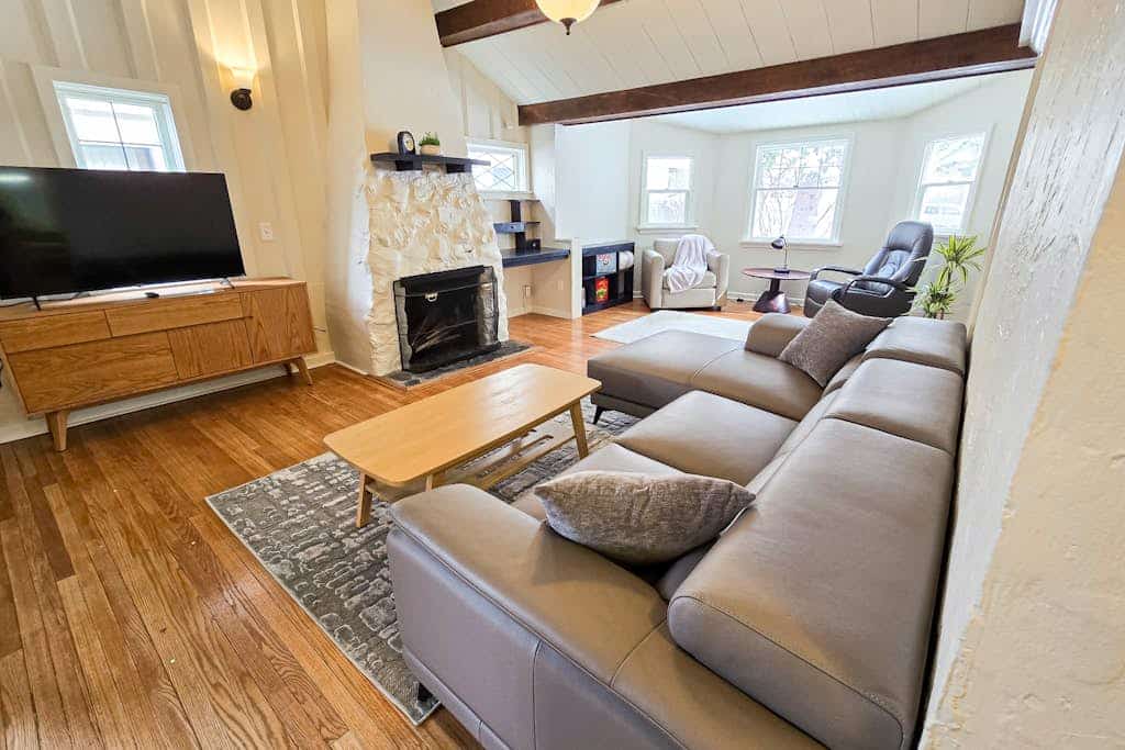 The kind of downtown Anchorage stay where you can completely park the car and walk to dinner. Nestled in a charming, established downtown neighborhood, this classic four-bedroom residence features three full bathrooms and a spacious layout that easily accommodates a group of ten without strain. Unwind after exploring the city around the authentic wood-burning fireplace, cook real meals in the fully equipped pro kitchen, or stream your favorite platforms over high-speed internet. Walking distance to the 5th Avenue Mall, the Anchorage Museum, boutique downtown shopping, and the waterfront bike paths along the Tony Knowles Coastal Trail. Standard Specs: Fully equipped kitchen, traditional wood-burning fireplace, three full bathrooms, private full-size washer/dryer, flat-screen TV, high-speed WiFi, and keypad entry. Neighborhood driveway parking for two vehicles. Cook Inlet waterfront is minutes away. Sleeps 10.