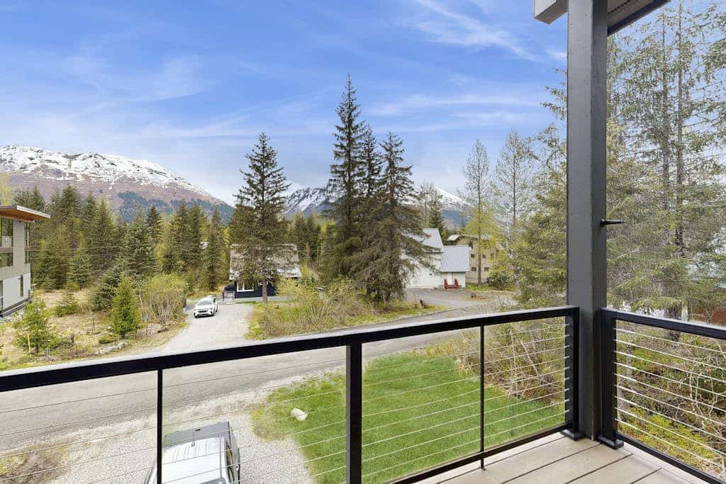 Constructed brand new in 2021 with sharp contemporary finishes and expansive viewing windows that frame the surrounding Chugach peaks, Glacier View Getaway makes a powerful case for the modern Girdwood home. Built specifically for large family groups and outdoor teams who want space without losing a classic mountain feel, the four-bedroom house features an open-concept kitchen built for real cooking and a massive, dedicated lower-level game room equipped with a custom foosball table. Positioned just minutes from Alyeska Resort, Girdwood Brewing Company, and local trailheads. Standard Specs: Gourmet full kitchen, private lower-level game room with foosball, contemporary finishes, large-capacity windows, flat-screen TV, high-speed WiFi, and keypad entry. Driveway parking for two vehicles. Sleeps 11.