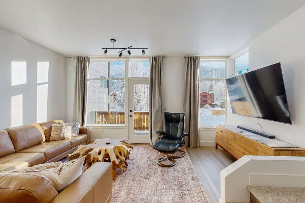 Brand new, masterfully designed, and positioned directly alongside the running waters of California Creek. Silver Tip Condo perfectly blends crisp modern comfort with rugged alpine utility, featuring dual outdoor viewing decks—a private creek-side deck at the back and an air-clearing mountain-view deck at the front. The high-end interior features clean modern lines, premium in-floor radiant heating throughout, a gas fireplace, and a large 75” Smart TV. Ditch the car keys and walk across a charming private footbridge spanning the creek for direct access to the Double Musky Restaurant, or take a short stroll to the local mercantile, grocery store, and shuttle loop. Standard Specs: Full kitchen with complete cookware, in-floor radiant heating, gas fireplace, 75” Smart TV, private creek/mountain decks, private in-unit washer/dryer, keypad entry, and front-door security camera. Parking for two vehicles. Strictly no parties/quiet hour compliance (10 PM–8 AM). Sleeps 4.