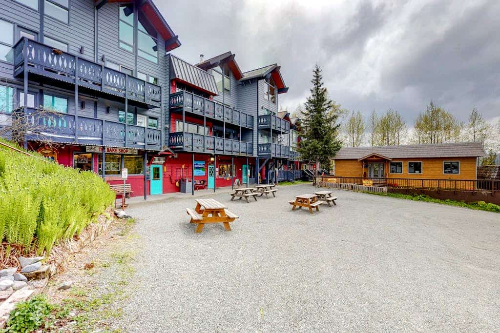 A small, quiet studio condo at the base of Alyeska Resort that lives much bigger than its footprint thanks to a rare, fully equipped kitchen with a dishwasher. Step out your door to ski straight to the lift line, or take a summer trek onto the North Face Trail starting just past the building loop. The layout features a private balcony perfect for morning coffee, clean mountain views, high-speed WiFi, and shared coin-operated laundry facilities on the first floor. Located a brief walk from local shops and fallback dining favorites like Sitzmark Bar & Grill. Standard Specs: Full kitchen with dishwasher, private balcony, flat-screen TV, high-speed WiFi, keypad entry, and shared building laundry. Parking space for two vehicles. True ski-in/ski-out access. Sleeps 2.