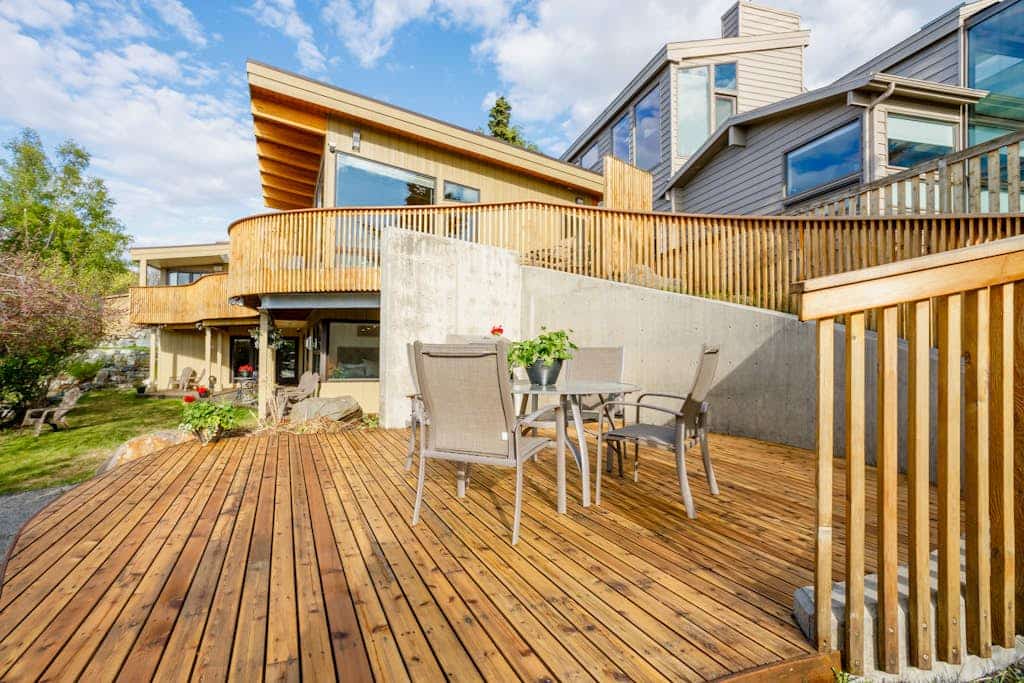 This high-utility group rental combines two independent, private-entry condos within the luxury M Street downtown Anchorage triplex into a single, connected three-bedroom configuration via a shared outdoor alcove patio. It is the perfect operational call when you need more scale than a single unit but don't require the full property compound. The interior showcases sleek industrial finishes, a built-in gas fireplace, a full kitchen plus an independent second kitchenette, and a master suite with walk-out access to the large garden patio. Outside, the grounds offer two completely private hot tubs and a shared landscaped garden looking out over Cook Inlet and Mt. Denali on clear days. Walk to the Coastal Trail and downtown eateries. Standard Specs: Full kitchen plus independent kitchenette, built-in gas fireplace, two private outdoor hot tubs, shared garden patio with gas grill, flat-screen TVs, high-speed WiFi, and keypad entry. Off-street parking for two vehicles. Involves a long entryway stairwell. Sleeps 9.