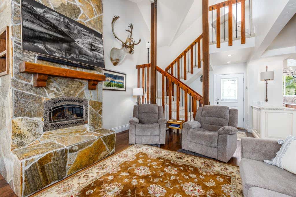Say hello to uncompromised luxury positioned directly slope-side at the base of Mt. Alyeska. Boasting striking, floor-to-ceiling window views of the ski resort from the living area, primary bedroom, and wide viewing deck, this beautifully appointed three-story townhome is engineered for premium ski vacations. The main living space is anchored by a majestic floor-to-ceiling rock fireplace, while the professional gourmet kitchen is a chef's dream—fully equipped with stainless steel appliances, double ovens, a warming drawer, a custom dining bar, and a commercial six-burner Wolf gas range. Ski straight to the lifts, ski back, and unwind in style. Standard Specs: Professional kitchen with six-burner Wolf range and double ovens, floor-to-ceiling stone fireplace, custom bar, viewing deck, flat-screen Smart TV, high-speed WiFi, and keypad entry. Three-story layout with driveway parking for two vehicles. Walk to the resort tram and restaurants. No smoking/vaping anywhere on premises. Sleeps 6.
