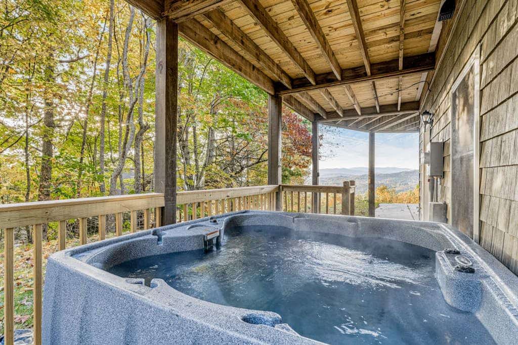 Gorgeous home with wraparound deck, mountain views, hot tub, sauna, & fireplace