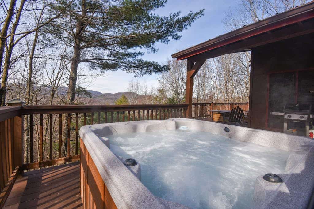 Dog-friendly peaceful cabin with wrap-around deck, hot tub, game tables, & grill