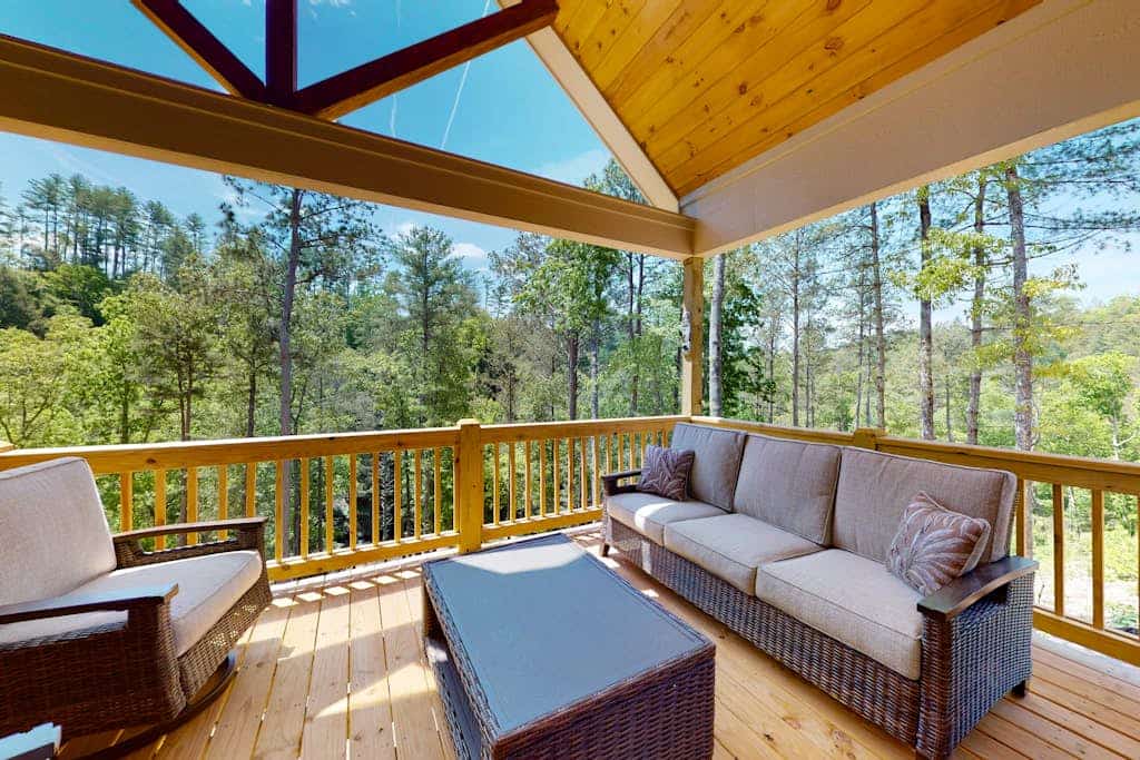 Calming river view Georgia home with fireplace, firepit, balcony, & hot tub