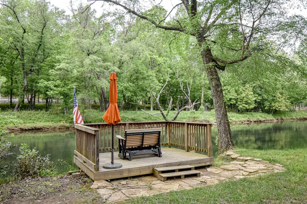 Riverfront cabin with private dock, firepit, wraparound porch & fireplace
