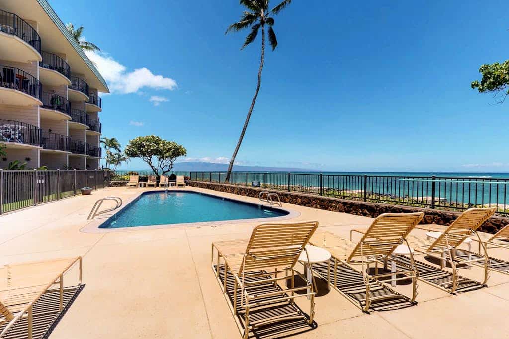 Ocean-view condo with balcony, pool, & sun loungers - walk to beach