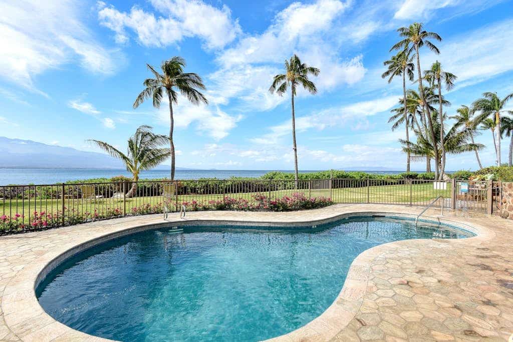 Waterfront gem with heated pool, hot tub, private beach, lanai, grill, W/D, & AC