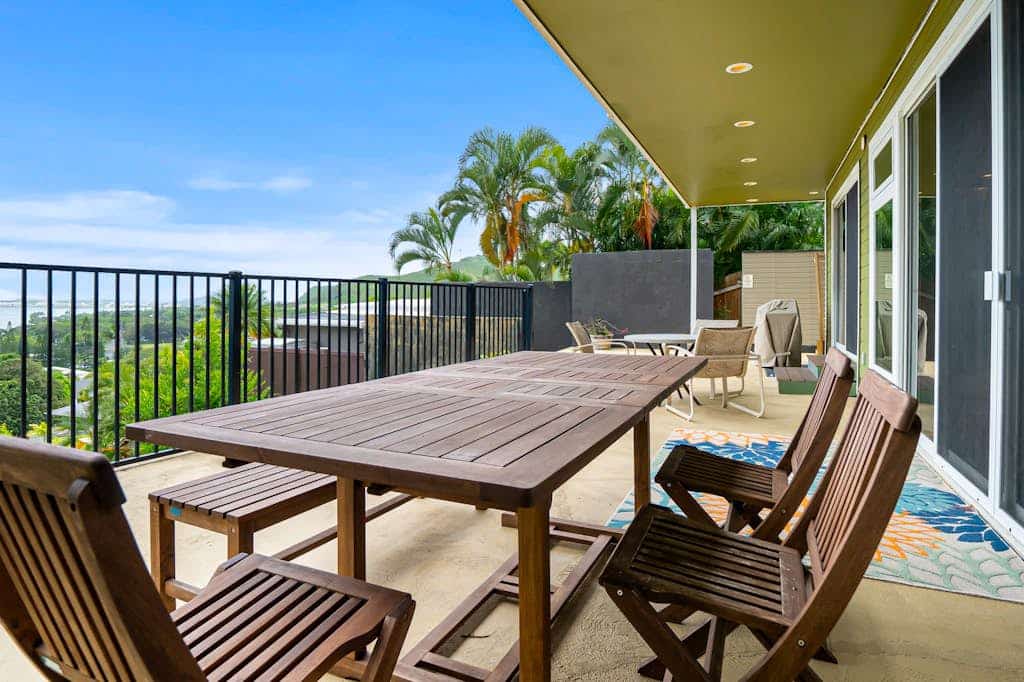 Two-story ocean view home with a furnished patio & deck, washer/dryer, & AC