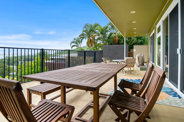 Two-story ocean view home with a furnished patio & deck, washer/dryer, & AC