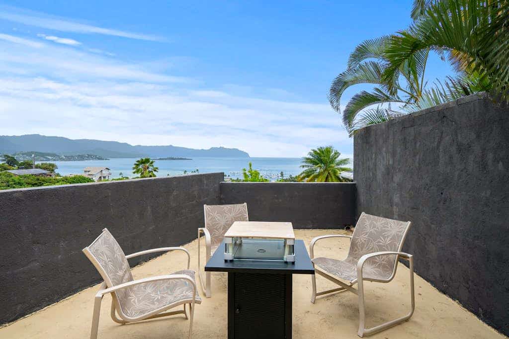Two-story ocean view home with a furnished patio & deck, washer/dryer, & AC