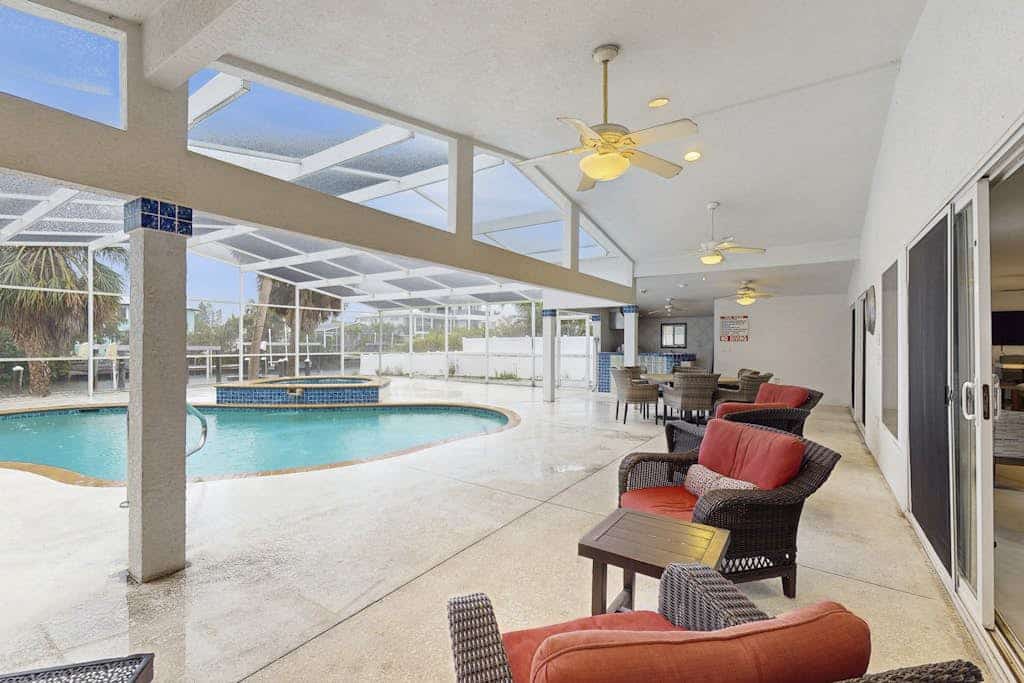 Waterfront dog-friendly home with heated private pool, dock, views, and lanai